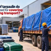 Tarpaulin Manufacturer supplying heavy-duty blue tarpaulin used to securely cover goods on a transport truck at an industrial facility